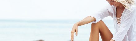 Woman with smooth skin relaxing on the beach